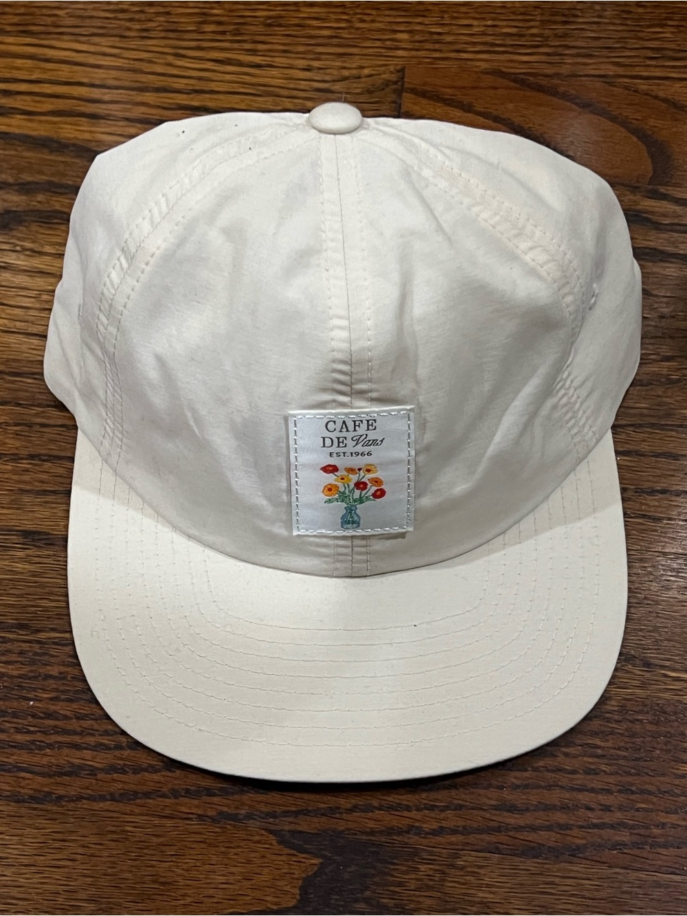 Cafe Vans Snapback Hat in cream, featuring a distinctive woven "Cafe De Vans"